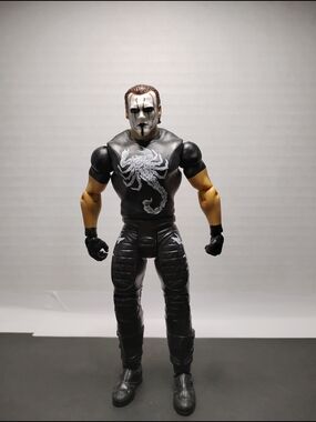Black Action Figure with Scorpion Chest Graphic